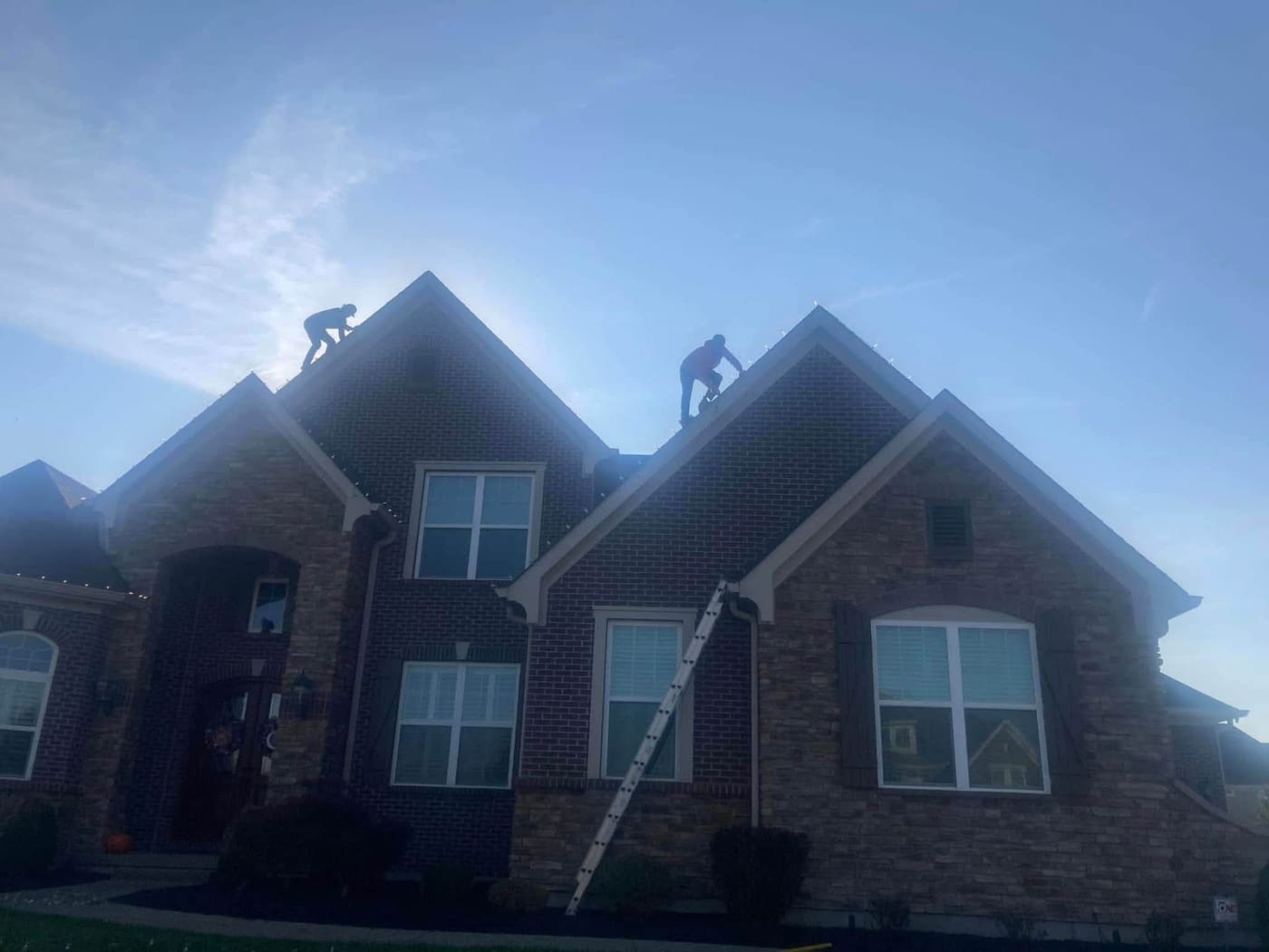 The Mike’s Outdoor Services crew on ladders installing lights on install day