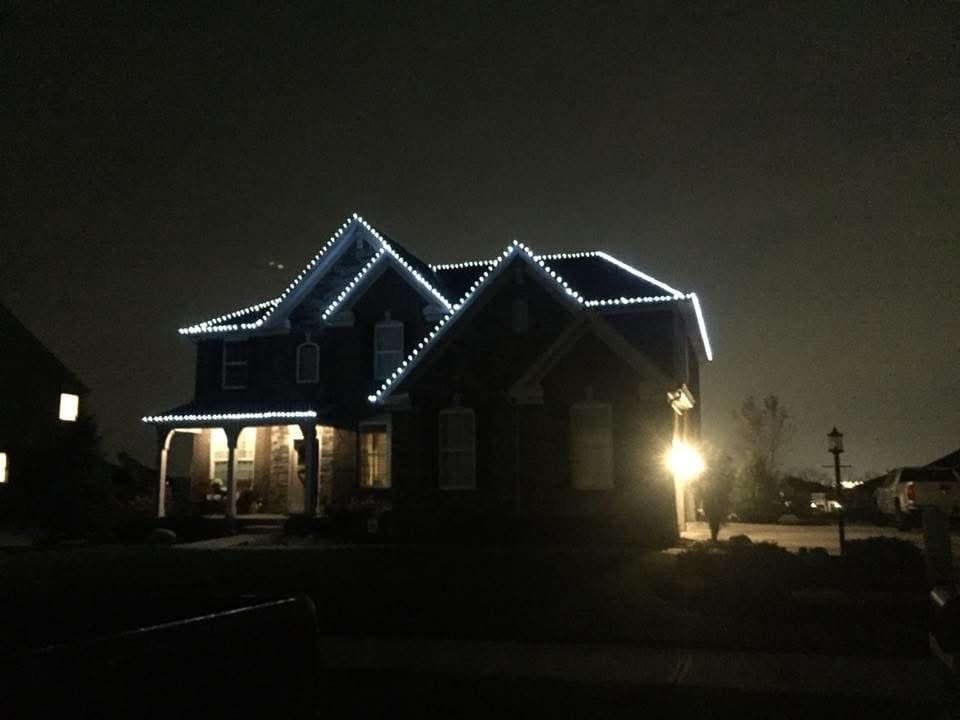 Crisp white roofline run picked out across a dark two storey house